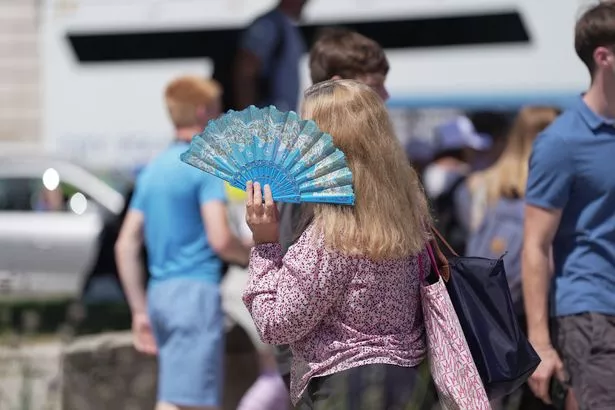 A person uses a fan in Westminster, London