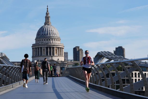 A person runs across the Millennium Bridge in London