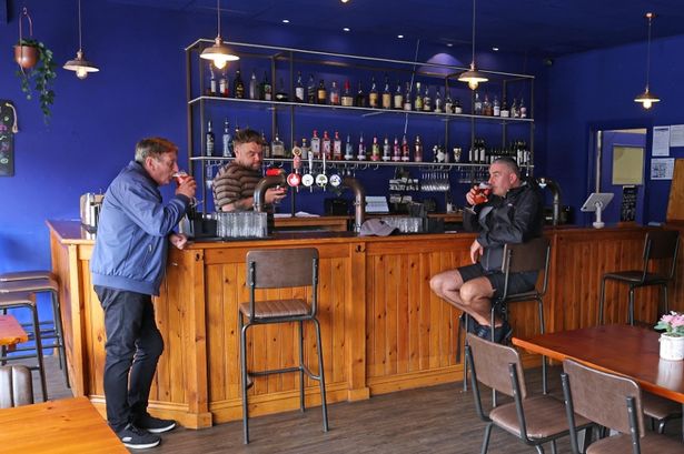 The Old Tavern's manager Tommy Powell serves customers