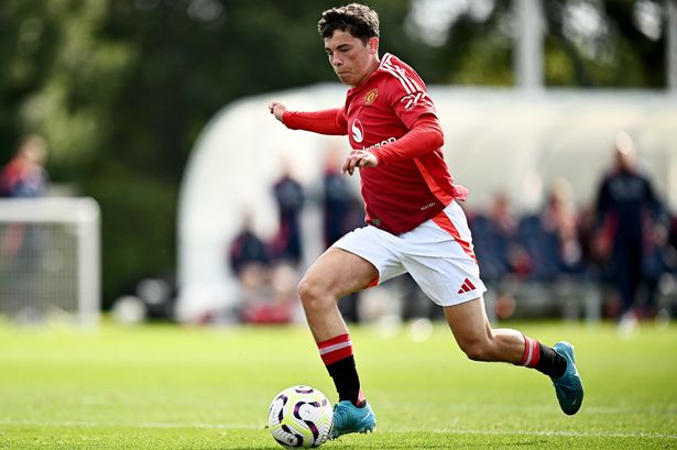 Shea Lacey dribbling with the ball during a Manchester United under-18s match