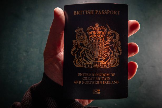 BATH, UNITED KINGDOM - FEBRUARY 2:  In this photo illustration, a man holds a post-Brexit United Kingdom issued passport on February 2, 2025 in Bath, England. Since leaving the European Union, the British passport is now a non-EU passport with a blue cover and a gold Royal crest. (Photo by Matt Cardy/Getty Images)
