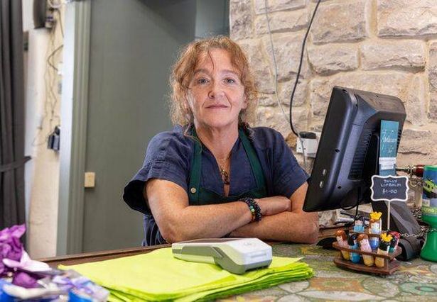 Val Grant behind counter at Old Apothecary Shop