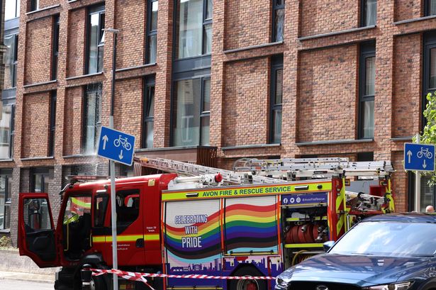 Fire service at the scene as water pours from Bristol flats