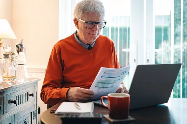 An older man looking at his bills
