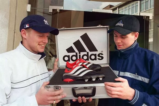 Liverpool's Steven Gerrard with Michael Ball of Everton outside Wade Smith sports store Mathew Street with the new adidas predator precision football boots in May 2000