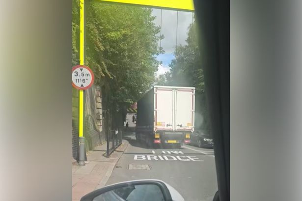The lorry starts to reverse back from the bridge on Barton Lane
