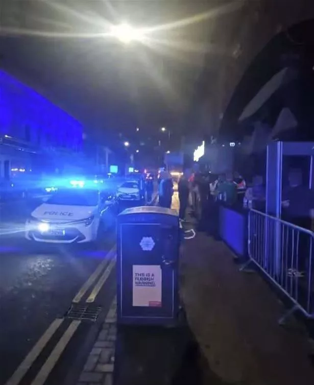 Police cars stopped outside MN1 on Whitworth Street West