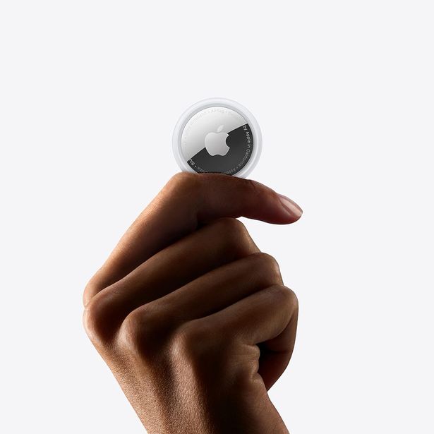 Person holding up AirTag