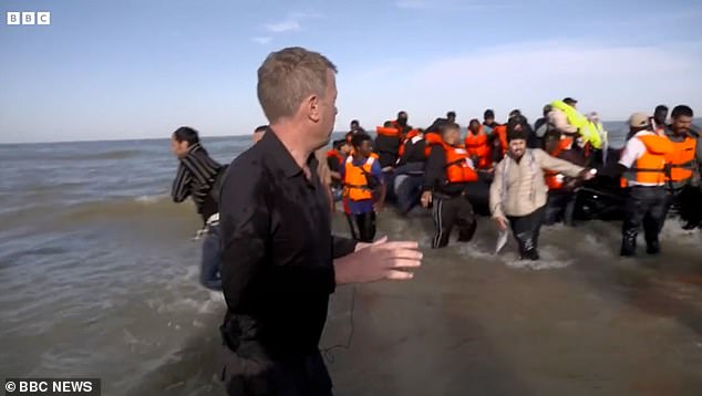 Migrants were seen hurrying back to shore after the intervention by police