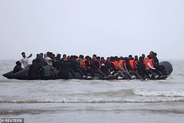 French and British authorities blame the spike on unusually good weather for the hike in attempted migrant crossings. Pictured: A group of migrants on an inflatable dinghy leave the coast of northern France in an attempt to cross the English Channel to reach Britain, from the beach of Petit-Fort-Philippe in Gravelines, near Calais, France, July 2