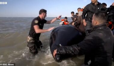French police slash migrant boat and drag passengers back to shore just as they attempt to cross the Channel for Britain