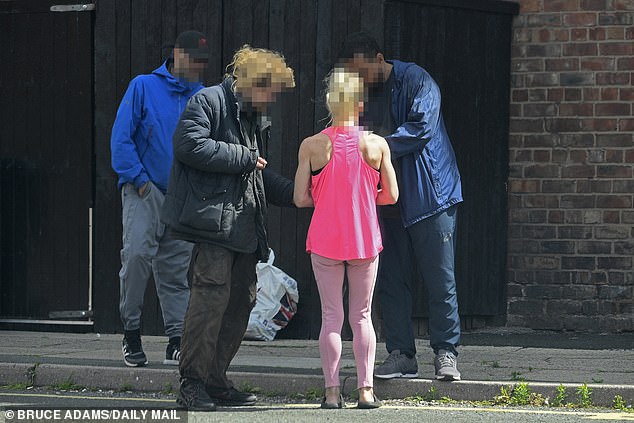 A group of people negotiate as they stand on the street in Walton