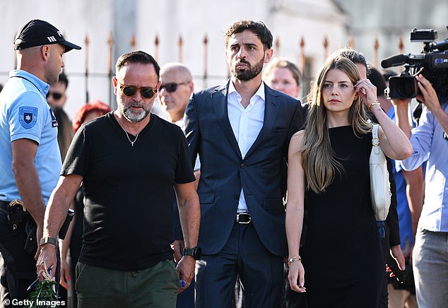 Manchetser City star Bernardo Silva (c), a fellow member of the Portguese national team, arrives for Jota's wake with wife Inês Tomaz (r)