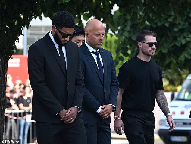 Liverpool manager Arne Slot, centre, was solemn as he attended the funeral service