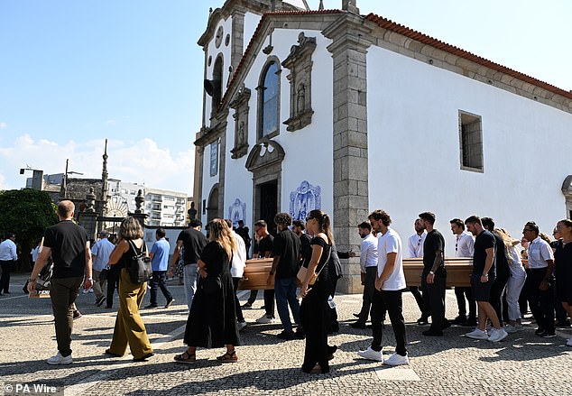 Members of the brothers' family carry their coffins into the church ahead of the service