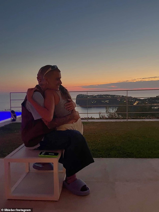 In the four-picture Instagram slideshow with Hailey, the 31-year-old pop star embraced her while relaxing poolside on a balcony overlooking a body of water during sunset
