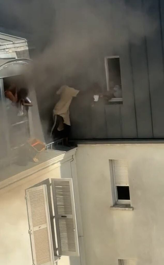 Fousseynou Cissé, 39, said he 'didn't think twice' about the danger as he stood on a ledge outside window to help those inside