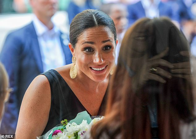 Meghan meets a well-wisher in Cape Town. Meghan's tendency to go off-script and rebel against the constraints of royal life were glaringly obvious during this royal tour