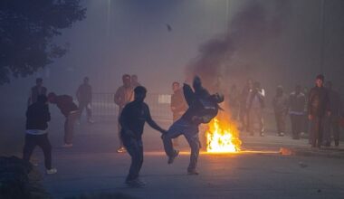 A man is seen throwing projectiles towards police during clashes between migrants and police