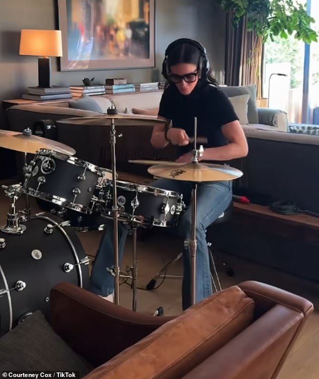 Sharing a clip to TikTok, she was seen sat at a four-piece drum set complete with two gold symbols and studio headphones