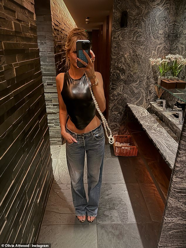 In another post, Olivia showed off her completed look, teaming her latex top with a pair of loose fitting jeans and heels