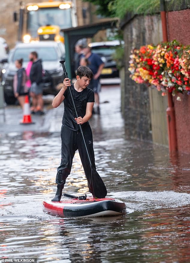 A paddleboarder braves the flooding in Newtown St Boswells in the Scottish Borders