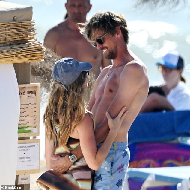 Abbey Clancy and Peter Crouch put on a very loved-up display as they spent the day at the beach during their family holiday to Almancil, Portugal