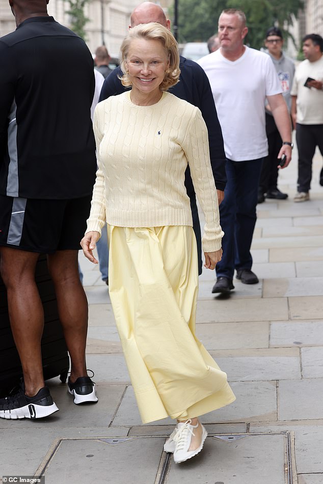 Pamela Anderson, 58, couldn't wipe the smile off her face as she departed London's Corinthia Hotel alongside Liam Neeson on Wednesday