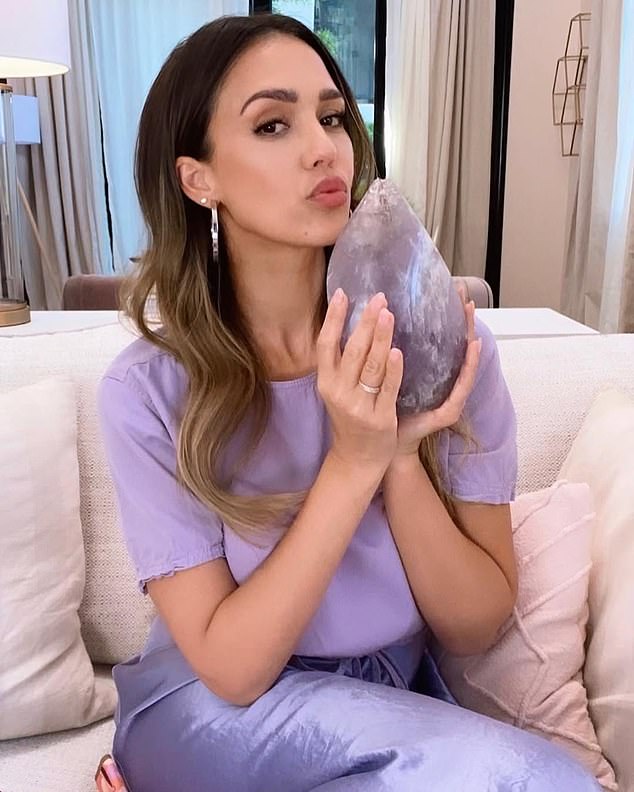 Alba's obsession with crystals is nothing new ¿ in a 2021 Instagram post (above), she shared a photo of herself clutching a massive purple amethyst ,writing, 'Let¿s be real¿I¿ve always been into collecting crystals'