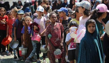 Palestinians gather in a charity kitchen to receive limited rations amid a shortage of food in Nuseirat refugee camp in the centre of the Gaza Strip