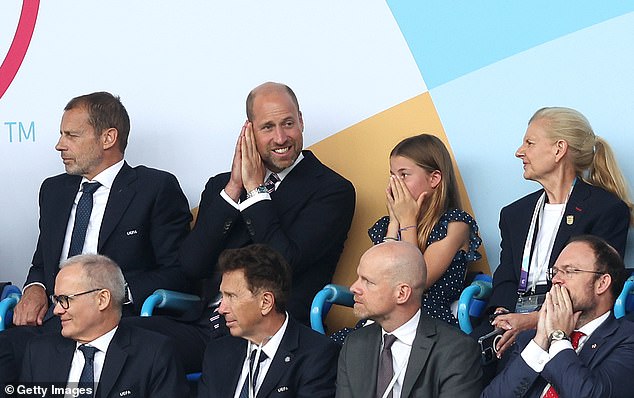 HRH Prince William, Prince Of Wales and Princess Charlotte of Wales look disappointed and dejected after Spain go 1-0 ahead