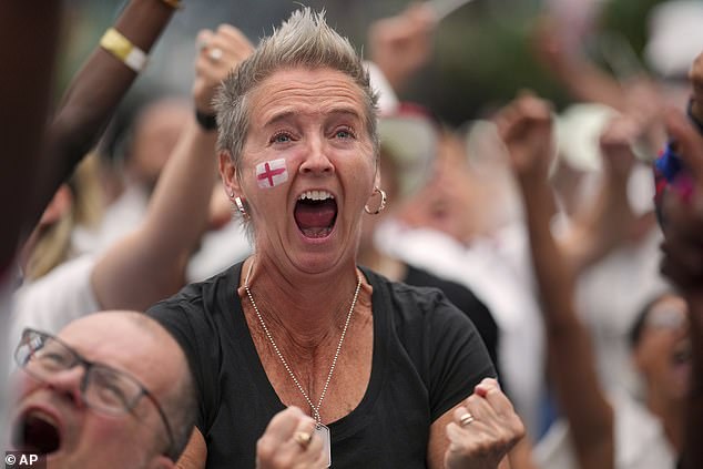England supporters celebrate during a live screening of the Women's Euro 2025 final soccer match between England and Spain at the Boxpark in Croydon