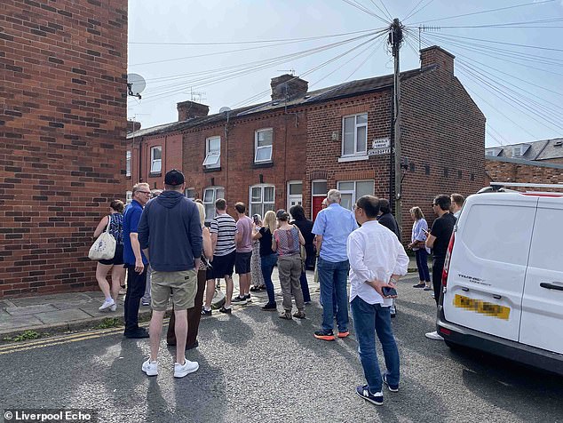 Crowds of Beatles fans gather at the chain at the end of Arnold Grove