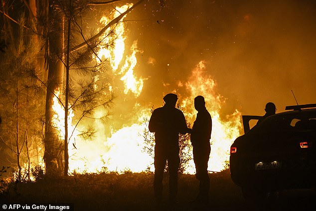 Extreme weather is wreaking havoc across Europe, pushing emergency services to their limits as wildfires heatwaves and storms sweep across the continent. Pictured: Firefighters work on a wildfire in Arouca, northern Portugal on July 30, 2025