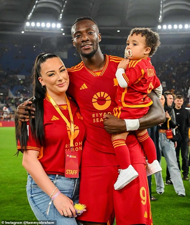 Abraham declared 'thank God my family are all OK'. It is not known who was in the property at the time of the break-in (pictured: the striker with his partner Leah Monroe and son Amari)