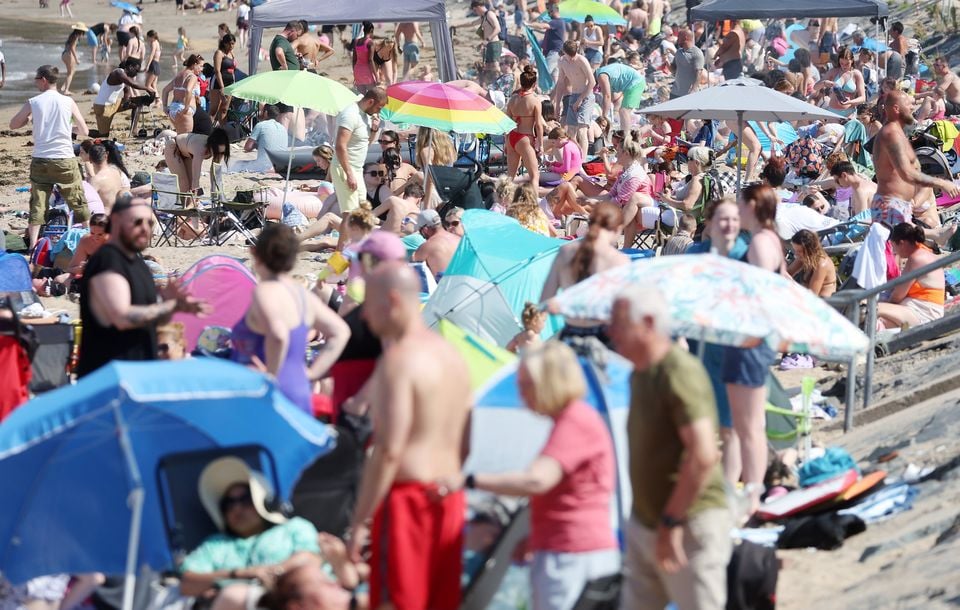 People enjoy the sun at Helen's Bay, Co. Down.