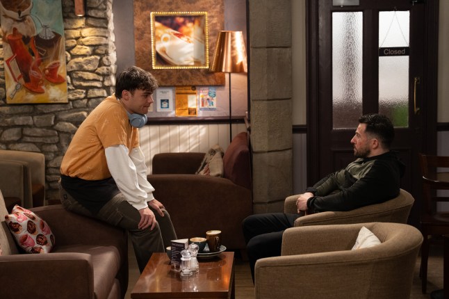 Lewis and Ross talk in the cafe in Emmerdale