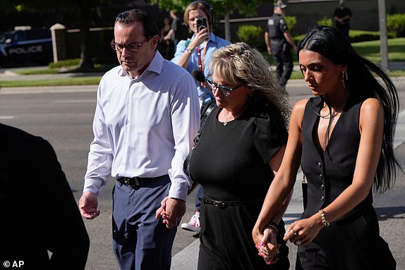Mother of Kaylee Goncalves, Kristi Goncalves, second from right, walks with family members including Steve Goncalves, left, to the Ada County Courthouse for Bryan Kohberger's plea deal hearing on Wednesday, July 2, 2025, in Boise, Idaho. (AP Photo/Jenny Kane)