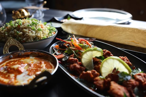 Rice, butter chicken, and other food served at the Indian Hive