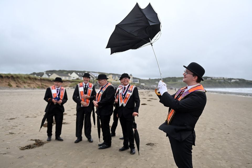 An Orange order member gets his umbrella out at Rossnowlagh on July 5, 2025 in Donegal, Ireland.  (Photo by Charles McQuillan/Getty Images)