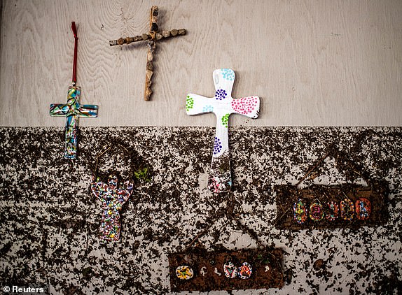Crosses hang on a wall with flood marks at Camp Mystic, in the aftermath of deadly flooding in Kerr County, Texas, U.S., July 7, 2025.   REUTERS/Sergio Flores