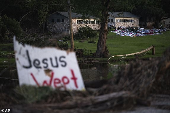 Camper's belongings sit outside one of Camp Mystic's cabins near the Guadalupe River, Monday, July 7, 2025, in Hunt, Texas, after a flash flood swept through the area. (AP Photo/Eli Hartman)