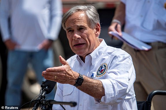 Texas Governor Greg Abbott speaks to the media at a press conference in the aftermath of deadly flooding in Hunt, Texas, U.S., July 8, 2025.   REUTERS/Sergio Flores