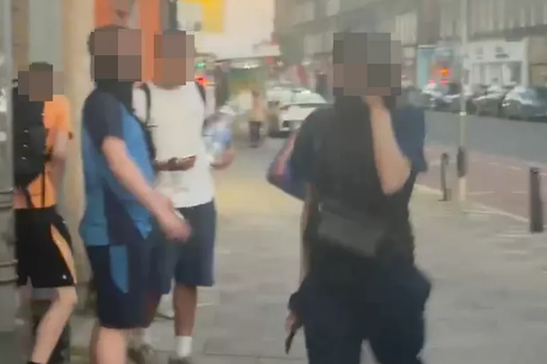 Two members of the gang appeared to brandish knives.