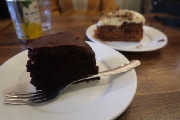A vegan chocolate cake and a slice of carrot cake from A Small Fish in a Big Pond