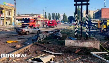 Damaged buildings and a car seen in Dobropillia in Ukraine's eastern Donetsk region