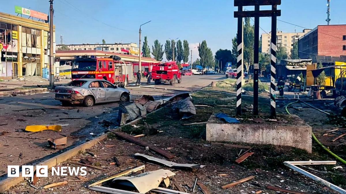 Damaged buildings and a car seen in Dobropillia in Ukraine's eastern Donetsk region