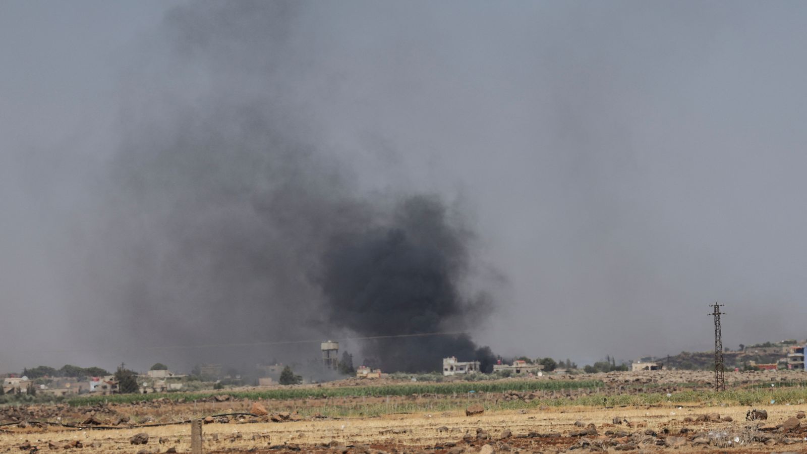Smoke rises over over Al-Mazra'a village, following renewed fighting between Bedouin and Druze , in Sweida, Syria. Pic: Reuters