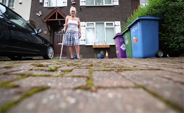 Gladys Bakken and her driveway which is being damaged by the roots of the trees on Lower House Road. Photo by Colin Lane