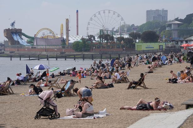 People enjoy the warm weather on the beach at Southend-on-Sea
